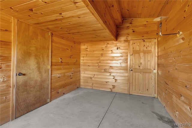 unfurnished room with wood ceiling, wood walls, concrete floors, and vaulted ceiling