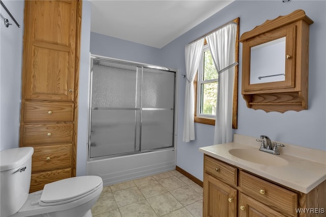 full bathroom featuring vanity, combined bath / shower with glass door, toilet, and tile patterned flooring