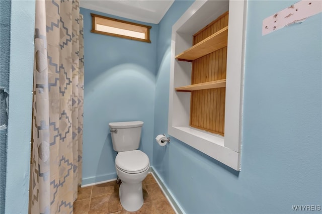 bathroom featuring walk in shower, toilet, and tile patterned flooring