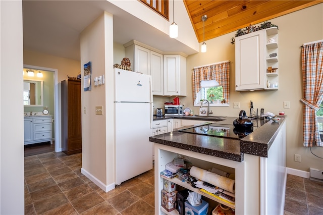 kitchen featuring white cabinets, vaulted ceiling, wood ceiling, and white fridge