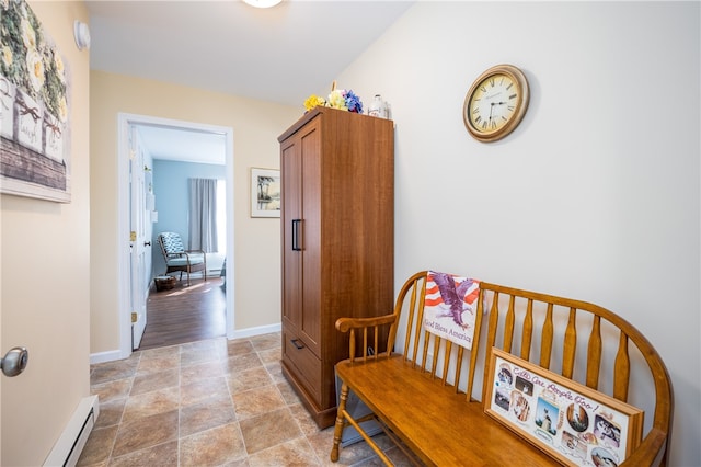 hallway featuring a baseboard radiator and light hardwood / wood-style flooring