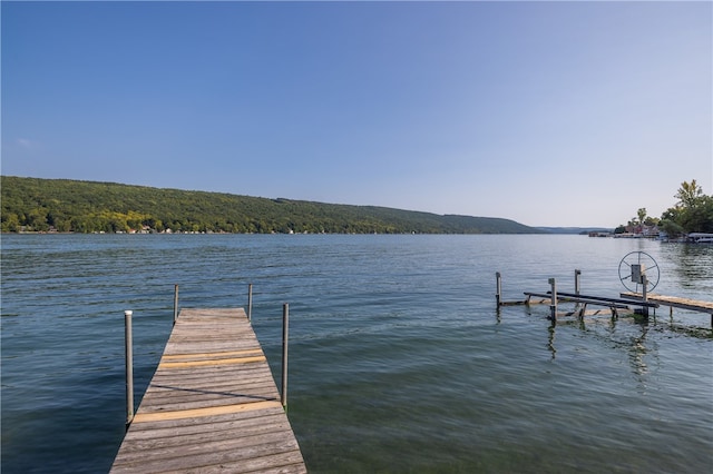 dock area featuring a water and mountain view