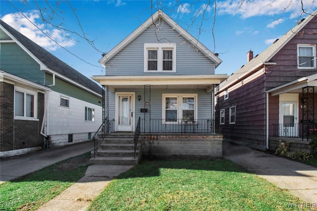 bungalow featuring a front yard and a porch