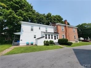 rear view of house with a lawn