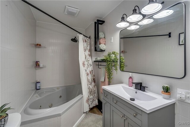 full bathroom featuring vanity, hardwood / wood-style floors, tile walls, toilet, and shower / bath combo with shower curtain