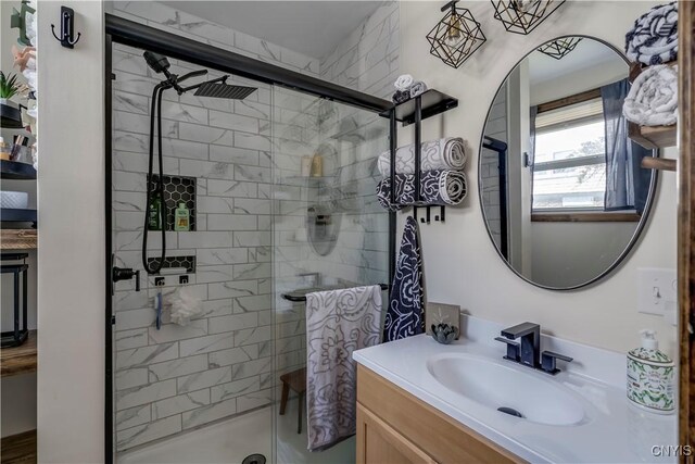 bathroom featuring walk in shower and vanity