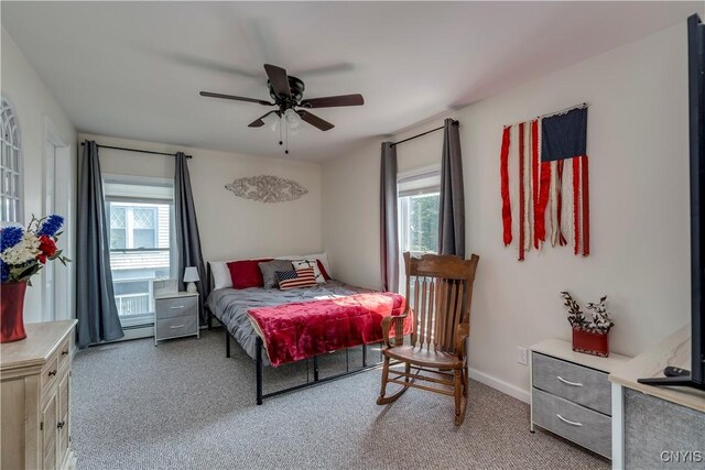 bedroom with ceiling fan and multiple windows