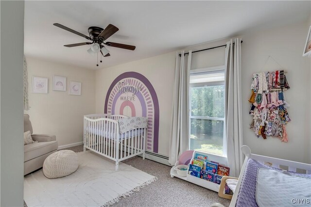 bedroom featuring a crib, ceiling fan, and carpet floors