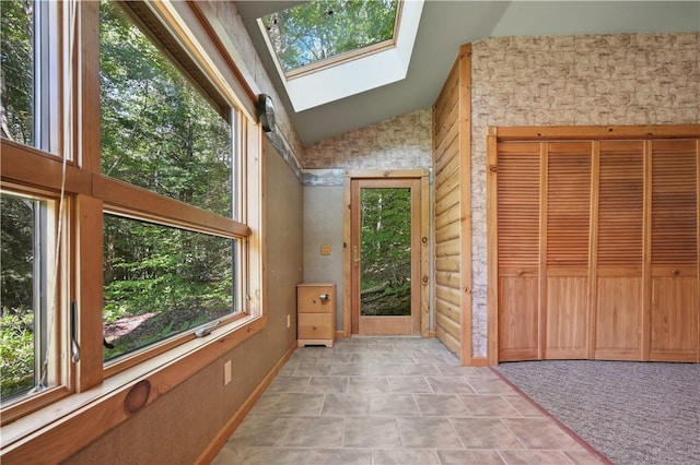 unfurnished sunroom with a skylight
