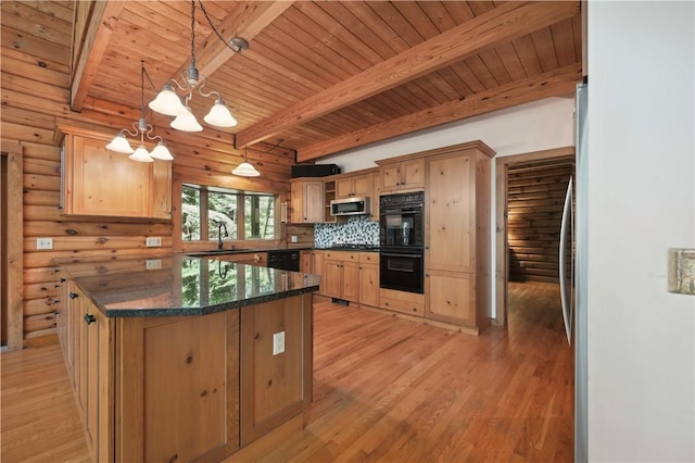 kitchen featuring an inviting chandelier, a sink, beamed ceiling, light wood-style floors, and black appliances