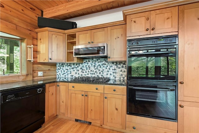 kitchen with beam ceiling, dark stone countertops, light wood-style floors, open shelves, and black appliances