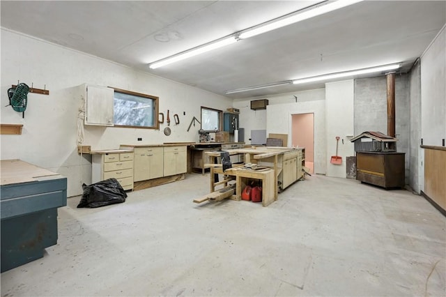 below grade area with a workshop area and a wood stove