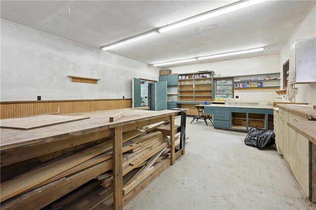 interior space featuring unfinished concrete floors and a workshop area