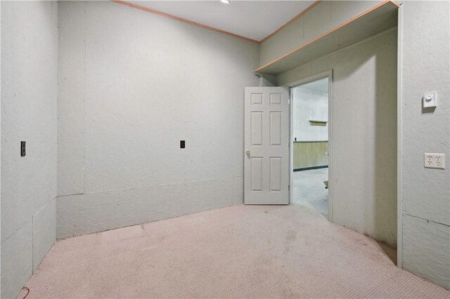 carpeted empty room with crown molding