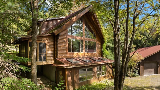 view of home's exterior with a sunroom and a garage