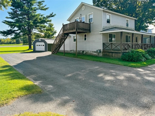 view of home's exterior featuring a porch and a yard