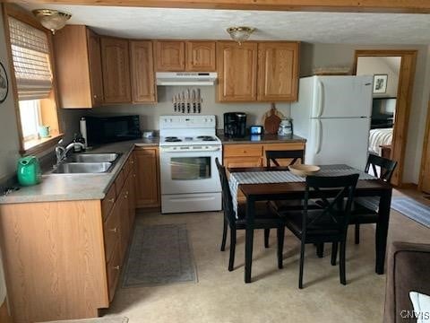 kitchen featuring white appliances and sink