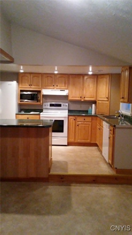 kitchen with vaulted ceiling, white appliances, and sink