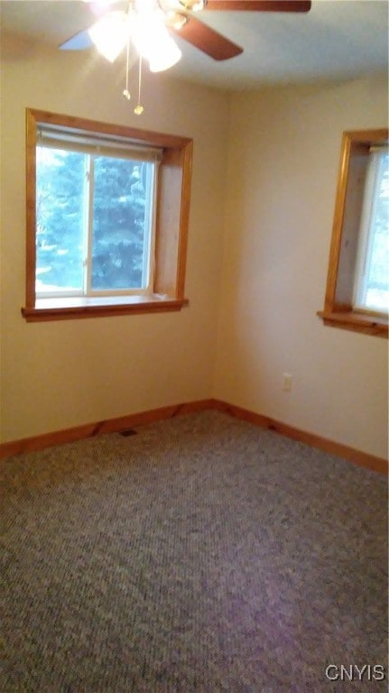 empty room with carpet flooring and ceiling fan