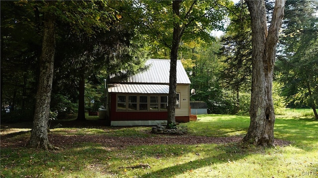 view of outbuilding featuring a lawn