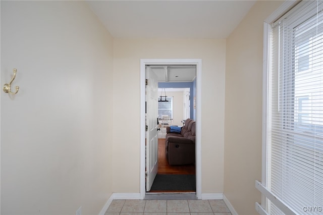 hall featuring light tile patterned floors