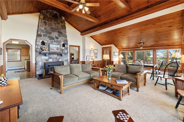 living room featuring ceiling fan, wood ceiling, light carpet, and a stone fireplace