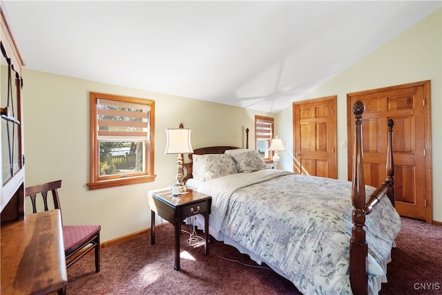 carpeted bedroom with lofted ceiling