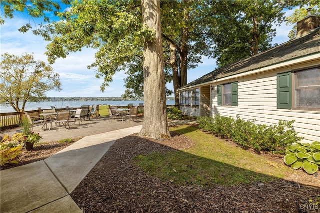 view of yard featuring a patio area and a water view