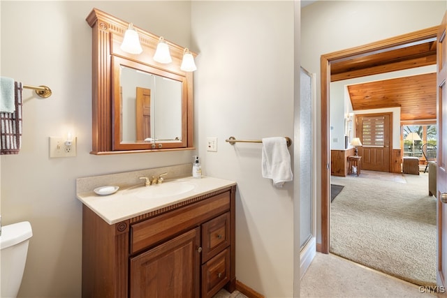 bathroom with vanity, toilet, and an enclosed shower