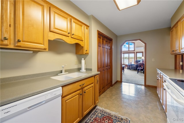 kitchen featuring white appliances and sink