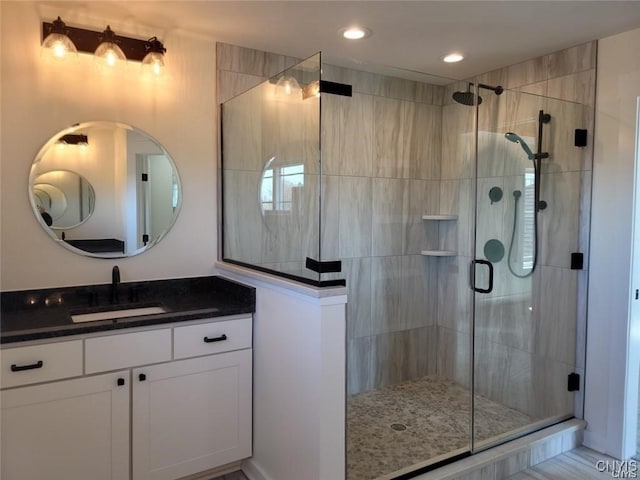 bathroom featuring vanity and an enclosed shower