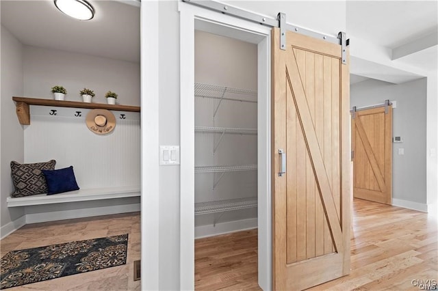 interior space with a barn door and light wood-type flooring