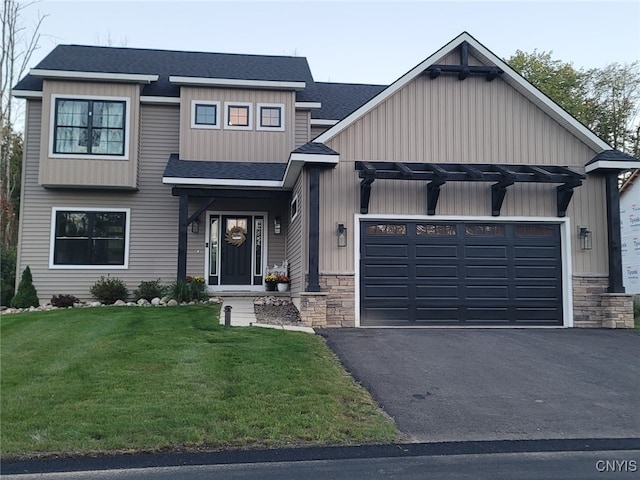 view of front facade with a garage and a front lawn