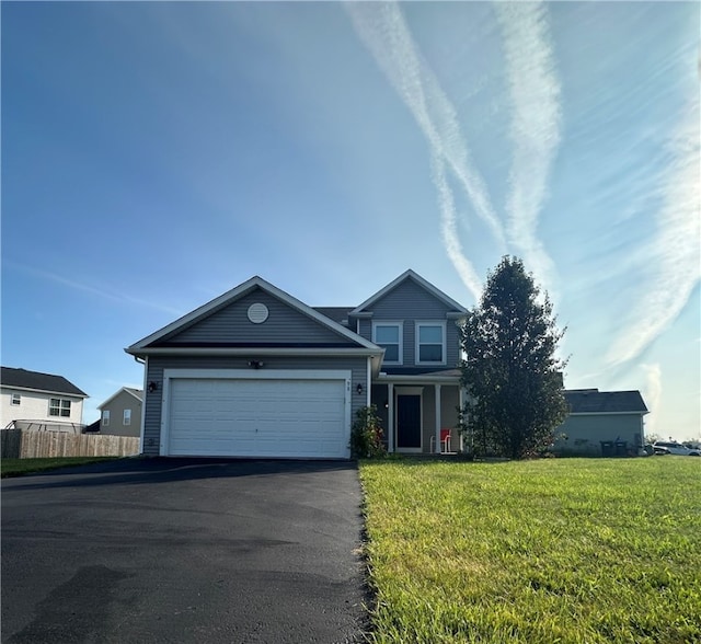 view of front of property featuring a garage and a front lawn