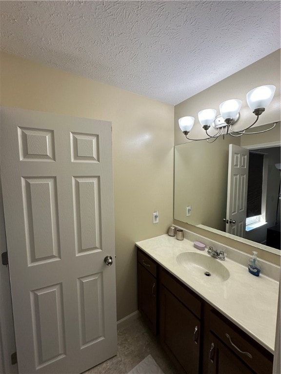 bathroom featuring a textured ceiling, vanity, and tile patterned flooring