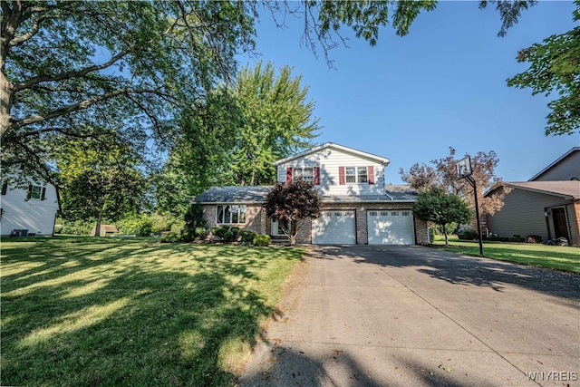 view of front of house with a garage and a front yard