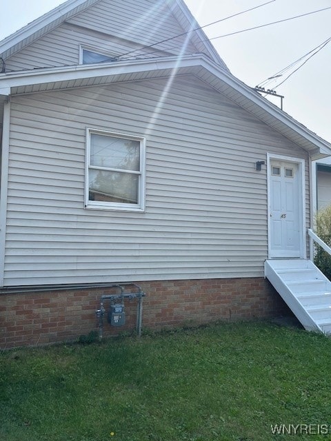 view of side of home with a lawn