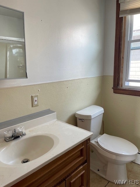 bathroom featuring tile patterned flooring, vanity, and toilet