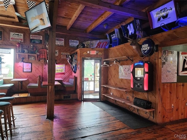 recreation room with hardwood / wood-style floors, wood ceiling, wooden walls, and beam ceiling