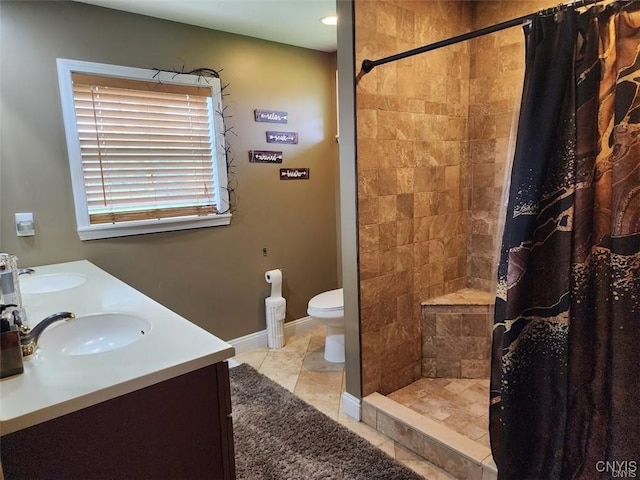 bathroom featuring tile patterned flooring, vanity, toilet, and curtained shower