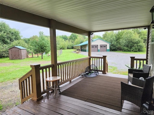 wooden deck with a yard, a shed, and a garage