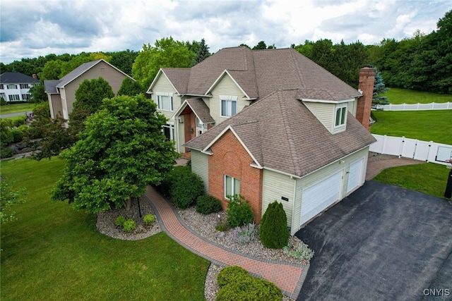 view of front of home featuring a front lawn and a garage