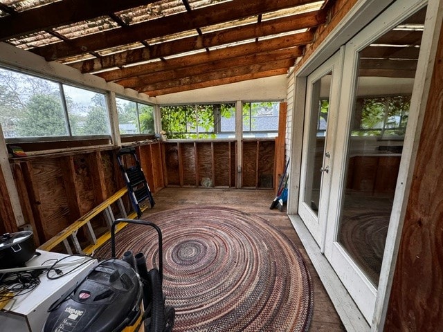 sunroom with vaulted ceiling with beams