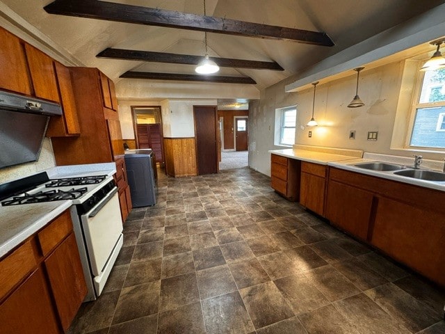 kitchen with pendant lighting, a wealth of natural light, white gas range oven, and lofted ceiling with beams