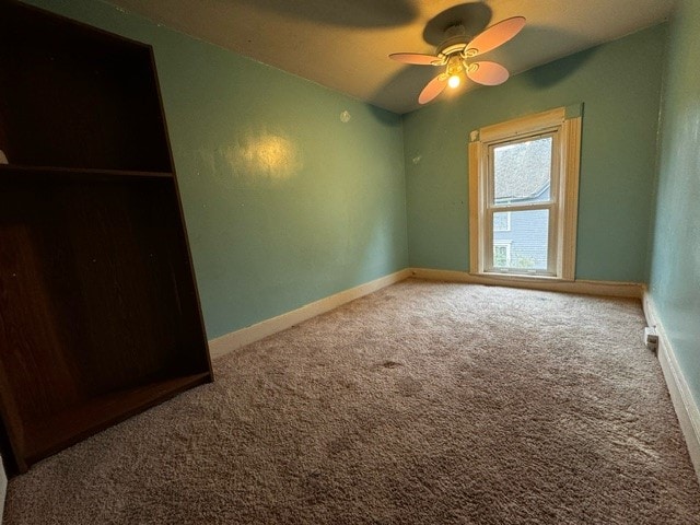 unfurnished bedroom with a closet, ceiling fan, and carpet flooring