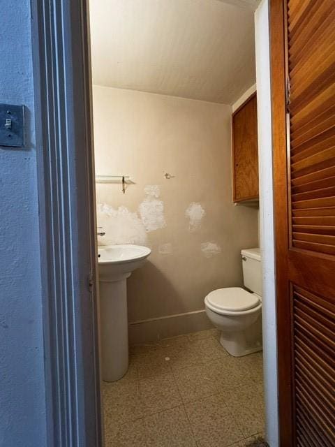 87 Canasawacta St, Norwich-City, NY 13815 - bathroom with toilet, tile patterned floors, and baseboards