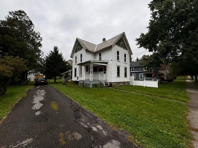 87 Canasawacta St, Norwich-City, NY 13815 - view of home's exterior with a chimney and a lawn