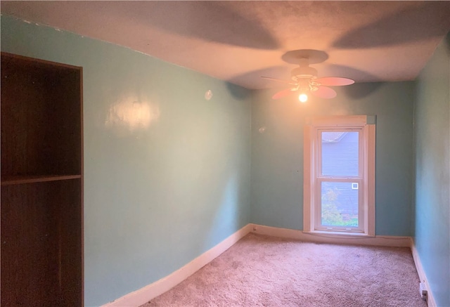 empty room featuring ceiling fan and carpet floors