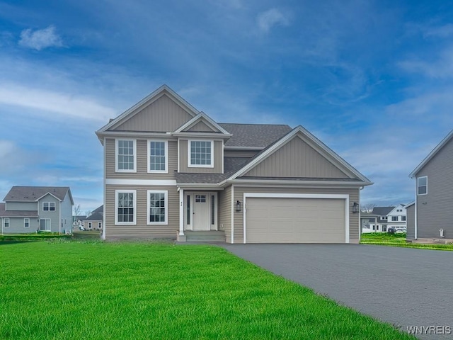 view of front of house featuring a front yard and a garage