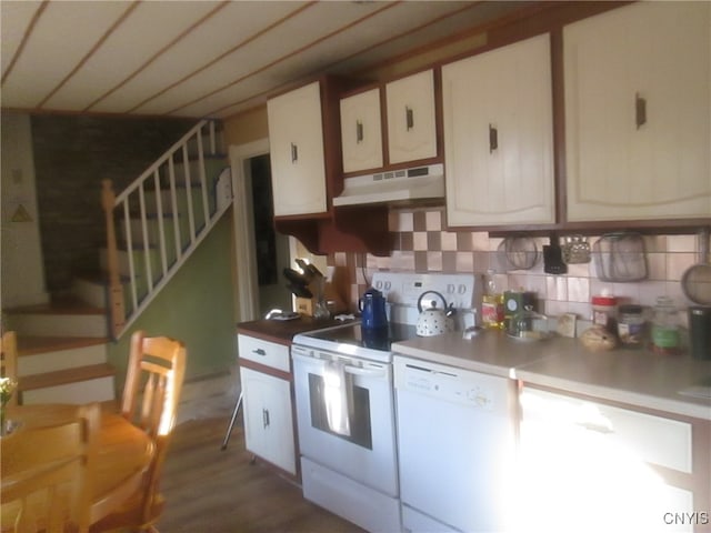 kitchen with decorative backsplash, white appliances, white cabinetry, and dark wood-type flooring